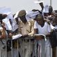 Job-seekers lie on the pitch after a stampede in Abuja National Stadium during the Nigerian immigration recruitment in 2014.