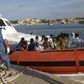 Rescued migrants arrive onboard a coastguard vessel at the harbour of Lampedusa October 3, 2013. REUTERS/Nino Randazzo/ASP press office/Handout via Reuters