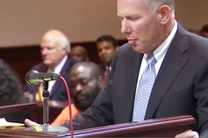 Rick Ross seated in the court while his attorney spoke on the bail bond