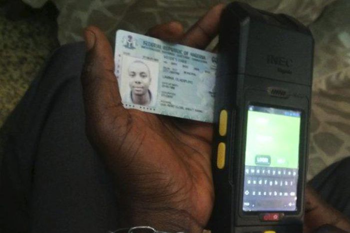 A Permanent Voter's Card being tested on a card reader meant for use in Nigeria's upcoming general elections.