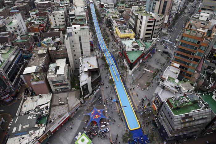 A 350-meter-long (1,148 feet) water slide seen during the 2015 City Silde Festa in central Seoul, South Korea.
