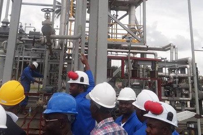 Workers at a refinery (File Photo)