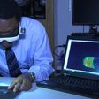 Dr. Samuel Achilefu demonstrating the use of the cancer-seeing glasses he developed
