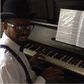 Basketmouth playing the piano