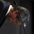 Toshiba Corp President and Chief Executive Officer Hisao Tanaka bows deeply as the start of news conference on panel to examine accounting issues in Tokyo May 15, 2015.