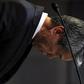 Toshiba Corp President and Chief Executive Officer Hisao Tanaka bows deeply as the start of news conference on panel to examine accounting issues in Tokyo May 15, 2015.