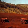 Trucks wait to be loaded with iron ore at the Fortescue Solomon iron ore mine located in the Valley of the Kings, around 400 km (248 miles) south of Port Hedland in the Pilbara region of Western Australia, in a file photo. REUTERS/David Gray