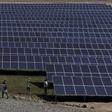 Workers walk past newly installed solar panels at the Honduran Solar Energy Company SA (COHESSA) and Solar Power SA (Soupy) solar power plant in Nacaome, Honduras, May 12, 2015.  REUTERS/Jorge Cabrera