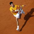 Novak Djokovic of Serbia returns the ball to Nicolas Almagro of Spain during their match at the Rome Open tennis tournament in Rome, Italy, May 12, 2015. REUTERS/Tony Gentile