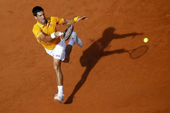 Novak Djokovic of Serbia returns the ball to Nicolas Almagro of Spain during their match at the Rome Open tennis tournament in Rome, Italy, May 12, 2015. REUTERS/Tony Gentile