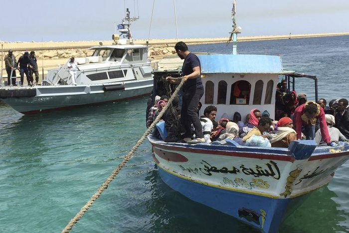 Illegal migrants who attempted to sail to Europe sit in a boat returning them to Libya as it is docked, after their boat was intercepted at sea by the Libyan coast guard, at Khoms, Libya May 6, 2015. REUTERS/Aymen Elsahli