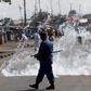 A policeman walks after throwing a teargas canister during a protest against Burundi President Pierre Nkurunziza and his bid for a third term in Bujumbura, Burundi, June 2, 2015. REUTERS/Goran Tomasevic