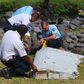 French gendarmes and police inspect a large piece of plane debris which was found on the beach in Saint-Andre, on the French Indian Ocean island of La Reunion, July 29, 2015.