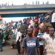 Crowd gathers near a bridge in Ijora Badia during a battle between police and robbers