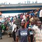 Crowd gathers near a bridge in Ijora Badia during a battle between police and robbers