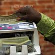 A bureau de change operator counts U.S. currency notes in Abuja, March 12, 2015. REUTERS/Afolabi Sotunde