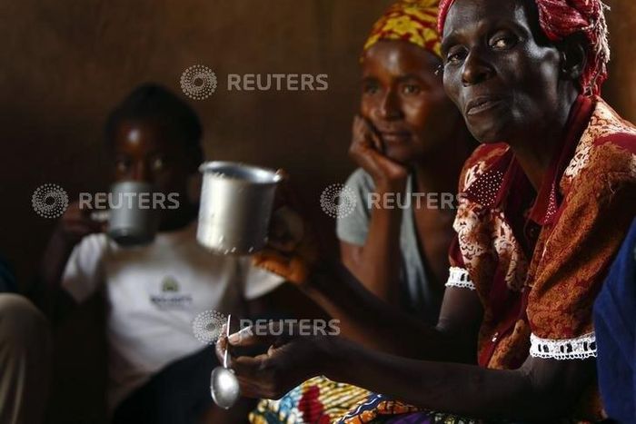 HIV-positive members of a self-help group meet with a caregiver in the village of Michelo, south of the Chikuni Mission in the south of Zambia February 23, 2015. REUTERS/Darrin Zammit Lupi