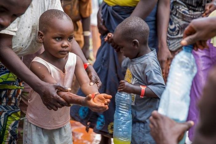A refugee boy from Burundi who fled the ongoing violence and political tension washes his hands at the Nyarugusu refugee camp in western Tanzania in this May 28, 2015 handout photo by PLAN INTERNATIONAL. REUTERS/Sala Lewis/PLAN INTERNATIONAL/Handout vi...