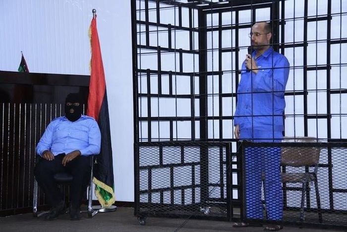 Saif al-Islam Gaddafi, son of late Libyan leader Muammar Gaddafi, attends a hearing behind bars in a courtroom in Zintan, June 22, 2014 . REUTERS/Stringer