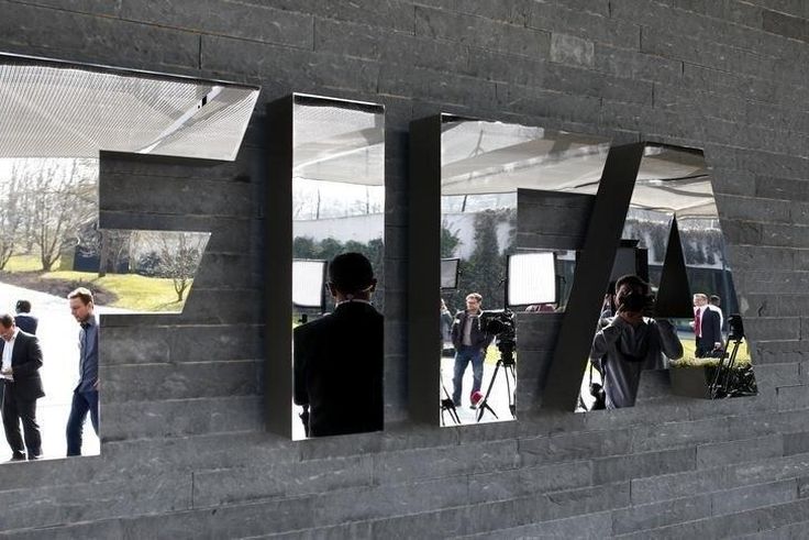 Journalists are reflected in the FIFA logo as they wait for a news conference after a meeting of the FIFA executive committee in Zurich March 20, 2015. REUTERS/Arnd Wiegmann
