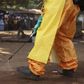 A member of the French Red Cross disinfects the area around a motionless person suspected of carrying the Ebola virus as a crowd gathers in Forecariah January 30, 2015.    REUTERS/Misha Hussain