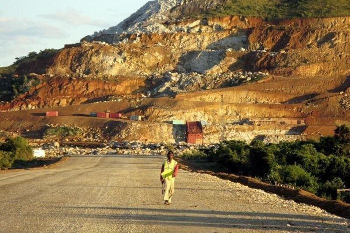 A Malagasy worker walks along an access track at mining giant Rio Tinto's project to construct an ilmenite (iron titanium oxide) mine in Fort Dauphin on Madagascar's south-eastern coast in this file photo. REUTERS/Ed Harris/Files