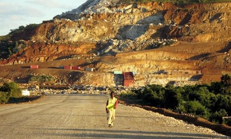 A Malagasy worker walks along an access track at mining giant Rio Tinto's project to construct an ilmenite (iron titanium oxide) mine in Fort Dauphin on Madagascar's south-eastern coast in this file photo. REUTERS/Ed Harris/Files