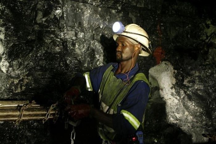 Mine workers is seend underground in Modderfontein east mine, outside Johannesburg, February 3, 2009.  South Africa's junior miner Aflease Gold said on Tuesday it aims to produce 500,000 ounces of the precious metal per year in five years based on the ...