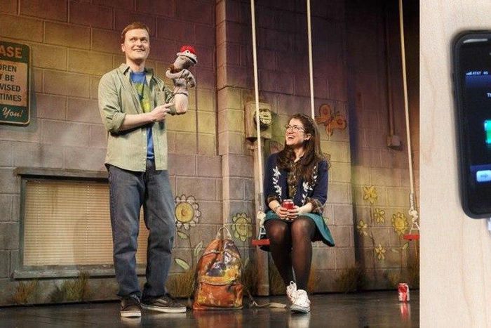 Left: The play continued after the disruption. Right: The iPhone the man tried to charge.