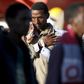 A member of police takes a picture of a migrant after disembarking from tug boat Asso29 in the Sicilian harbour of Pozzallo, southern Italy, May 4, 2015. REUTERS/Antonio Parrinello
