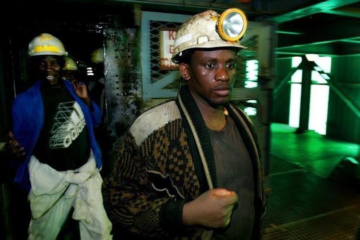 Mineworkers return at the end of an underground shift at the Harmony Gold Mine's Doornkop shaft near Johannesburg, in a file photo. REUTERS/Mike Hutchings