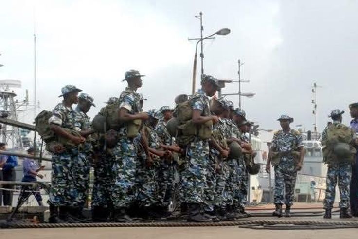 Naval officers receiving instructions from their superior.