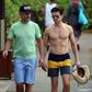 A shirtless Matt Bomer and husband Simon Halls in Hawaii