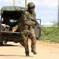 A Kenya Defense Force soldier runs for cover near the perimeter wall where attackers are holding up at a campus in Garissa April 2, 2015. REUTERS/Noor Khamis