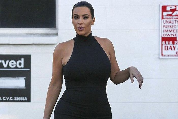 Kim Kardashian shows off baby bump in skintight black dress