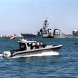 Yemeni marine police patrol around the damaged destroyer USS Cole as it is towed out of Aden harbor on October 29, 2000 -- US President Donald Trump has confirmed that a key plotter of the attack was killed in a US air strike
