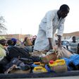 A man arranges the belongings of migrants into the back of a truck at a local transit centre in the desert town of Agadez, Niger May 25, 2015. REUTERS/Akintunde Akinleye
