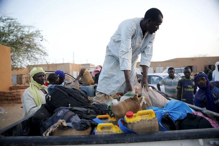 A man arranges the belongings of migrants into the back of a truck at a local transit centre in the desert town of Agadez, Niger May 25, 2015. REUTERS/Akintunde Akinleye