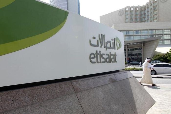 A man walks past a sign at the headquarters of telecommunications company Etisalat in Dubai October 25, 2011. REUTERS/Jumana El Heloueh