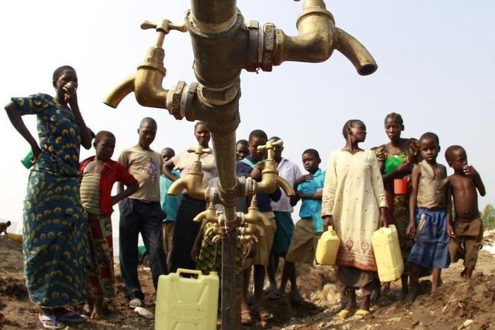 Congolese refugees, displaced by fighting between the Congo army and rebel group Allied Democratic Forces (ADF) last week, gather around dry water taps at Bukanga transit camp in Bundibugyo town camp, 376km (238 miles) southwest of Kampala July 17, 201...