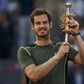 Britain's Andy Murray raises up his trophy after winning the final match over Spain's Rafael Nadal at the Madrid Open tennis tournament in Madrid, Spain, May 10, 2015. REUTERS/Sergio Perez