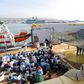 A crew member looks on as migrants wait to disembark from the Norwegian vessel Siem Pilot at Catania's harbour, Italy, June 30, 2015. REUTERS/Antonio Parrinello