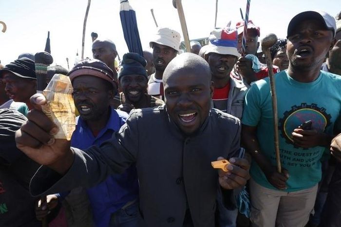 Striking platinum miners sing and dance during a rally near Lonmin's Marikana mine April 29, 2014. REUTERS/Mike Hutchings