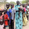 Residents displaced due to the recent fighting between government and rebel forces in the Upper Nile capital Malakal wait at a World Food Program (WFP) outpost where thousands have taken shelter in Kuernyang Payam, South Sudan, May 2, 2015. REUTERS/Den...