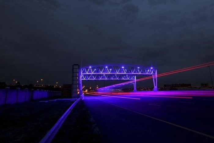 Cars drive under a road toll in Johannesburg December 2, 2013.    REUTERS/Siphiwe Sibeko