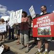 Protesters rally outside the River Bluff Dental clinic against the killing a famous lion in Zimbabwe, in Bloomington, Minnesota July 29, 2015. REUTERS/Eric Miller