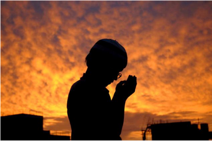 A young Muslim boy praying