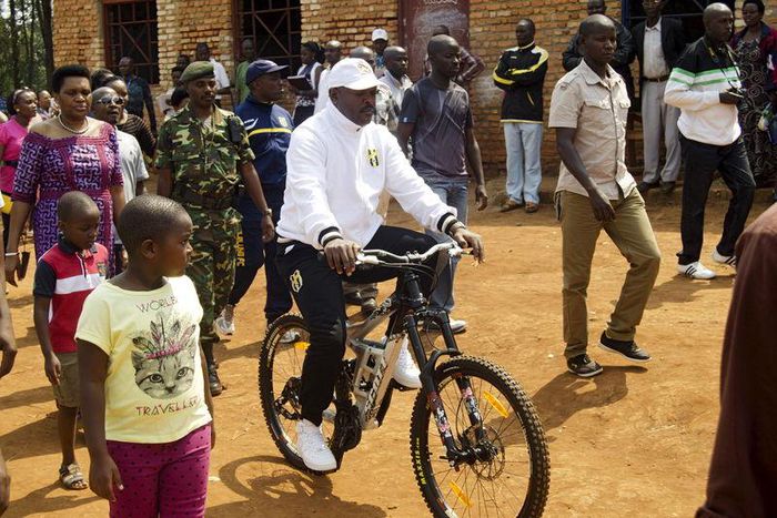 President Pierre Nkurunziza rides a bicycle as he heads to the venue where he voted in at a polling station in his rural home in Ngozi during a parliamentary election in Burundi June 29, 2015. REUTERS/Stringer