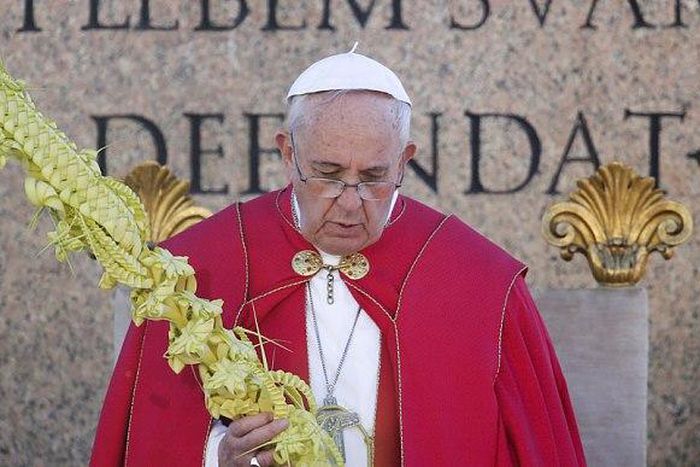 Pope Francis prays during Palm Sunday Mass