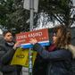 Members of Amnesty International hang a sign reading "Jamal Khashoggi Street" where the Saudi Arabian consulate is located in Istanbul, during a ceremony marking 100 days since the murder of the journalist there